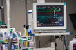 © Rungruedee - Vital signs monitor with machines during surgery on a patient in operating room.