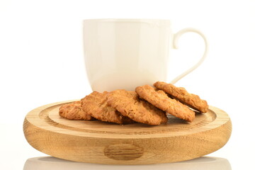 Several delicious torchetti cookies with oatmeal on a wooden tray with a white cup, close-up, isolated on white.