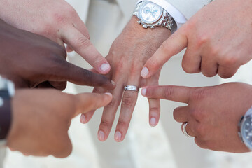 Wall Mural - Groom with his friends pointing at his ring