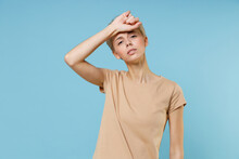 Young Blonde Sick Tired Ill Caucasian Woman 20s Short Haircut Nude Make Up In Casual Basic Beige T-shirt Hand On Forehead Have Headache Look Camera Isolated On Blue Color Background Studio Portrait