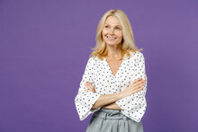 Smiling Elderly Gray-haired Blonde Woman Lady 40s 50s Years Old Wearing White Dotted Blouse Standing Holding Hands Crossed Looking Aside Isolated On Bright Violet Color Background Studio Portrait.