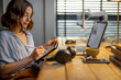 © rh2010 - Young woman dressed casually having some creative work, drawing on a digital tablet, sitting at the cozy and stylish home office