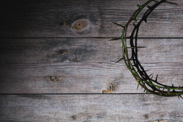 close up of crown of thorns of jesus on top of the holy bible on wooden table can be used for christ