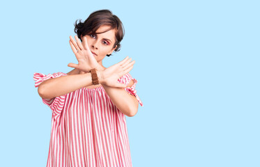 Sticker - Beautiful young woman with short hair wearing casual summer clothes rejection expression crossing arms and palms doing negative sign, angry face