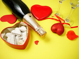 red box with heart shape with bow, bottle of champagne and two glasses, valentine's day party concept