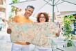 © Krakenimages.com - Middle age couple on vacation smiling happy holding map at street of city.