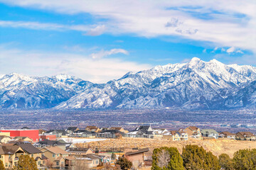 Wall Mural - Magnificent snowy Wasatch Mountain towering over a neighborhood and valley