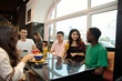 © etonastenka - Multiracial happy young people drink coffee at cafe, black and white cheerful mates laughing enjoying drinks having fun sitting together at restaurant table, diverse friends share lunch at meeting