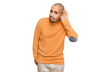 Wall Mural - Hispanic adult man wearing casual winter sweater smiling with hand over ear listening an hearing to rumor or gossip. deafness concept.