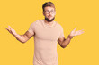 © Krakenimages.com - Young caucasian man wearing casual clothes and glasses clueless and confused expression with arms and hands raised. doubt concept.
