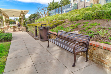 Wall Mural - Bench on park pathway in the scenic neighborhood of Huntington Beach California