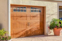 Brown Glass Paned Wooden Garage Door Of Home In Huntington Beach California