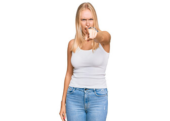 Canvas Print - Young blonde girl wearing casual style with sleeveless shirt pointing displeased and frustrated to the camera, angry and furious with you