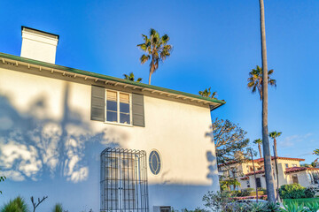 Canvas Print - Home with shutters and grills on window against blue sky in San Diego California