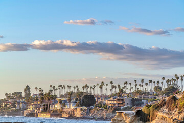 Buildings and palm trees at the coast of San Diego California against cloudy sky