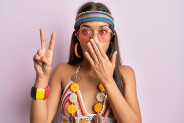 Sticker - Beautiful hispanic woman wearing bohemian and hippie style doing peace symbol covering mouth with hand, shocked and afraid for mistake. surprised expression