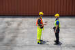 © ronnachaipark - staff worker standing and checking the containers box from cargo ship for export and import