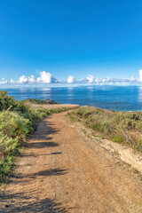 Wall Mural - Dirt trail path overlooking blue sea and cloudy sky at Laguna Beach California