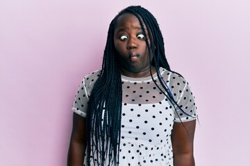 Poster - Young black woman with braids wearing casual clothes making fish face with lips, crazy and comical gesture. funny expression.