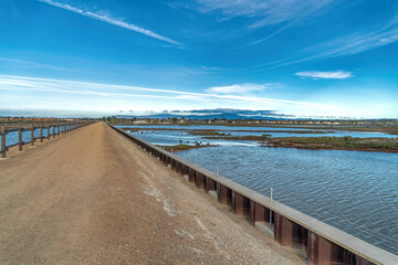  Footbridge and scenic wetlands in Bolsa Chica Nature Reserve Huntington Beach CA