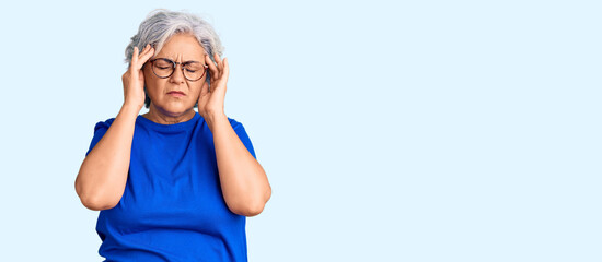 Poster - Senior woman with gray hair wearing casual clothes and glasses suffering from headache desperate and stressed because pain and migraine. hands on head.