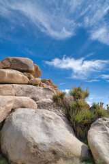 Mountain of huge rocks against blue sky and clouds at Joshua Tree National Park