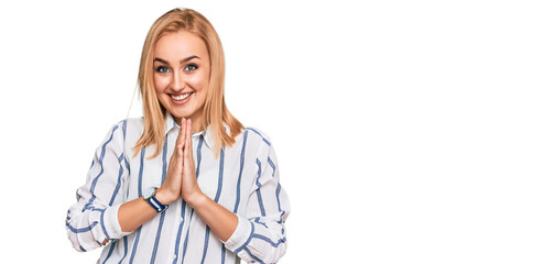 Beautiful caucasian woman wearing casual clothes praying with hands together asking for forgiveness smiling confident.