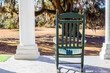 © ehrlif - Single empty rocking chair on the front porch of an antebellum style house in the southern United States.