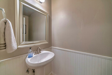 Wall Mural - Wall mount sink mirror with white frame and lights inside bathroom of a home