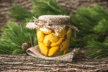 Delicious Preserved Marinated Small Yellow Summer Squash, Also Known As Patty Pan Squash In The Glass Jar. Rustic Style