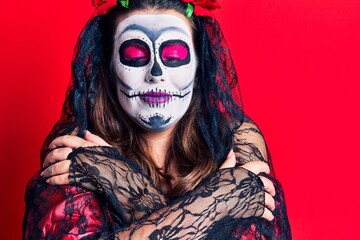 Poster - Young woman wearing day of the dead costume over red hugging oneself happy and positive, smiling confident. self love and self care