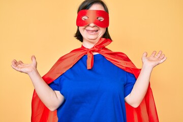 Sticker - Brunette woman with down syndrome wearing super hero costume celebrating mad and crazy for success with arms raised and closed eyes screaming excited. winner concept