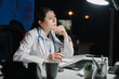 © PR Image Factory - Serious thoughtful asian chinese woman doctor working with computer at table in dark workplace. pensive lady medical staff frowning and staring at pc screen thinking solution of patient problem.