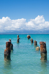 Wall Mural -  The remnants of an old dock in the turquoise water off Isla de Cajo de Muertos, Puerto Rico, USA.  