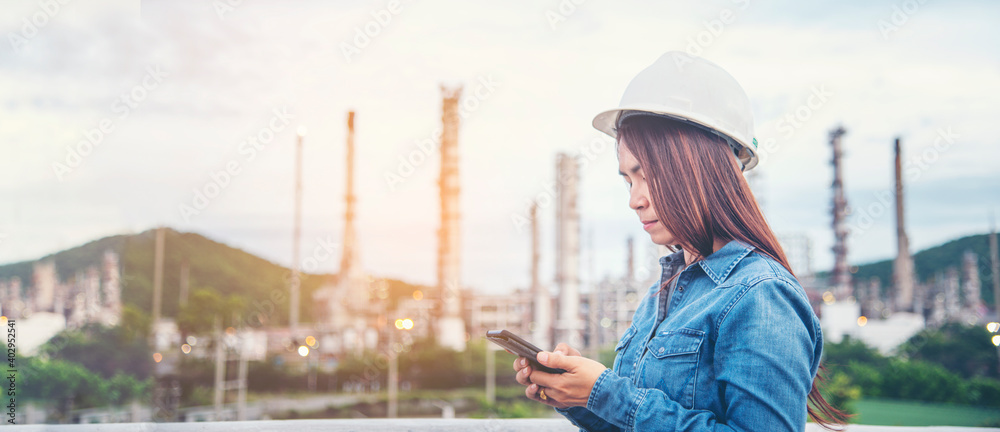 Woman engineer entrepreneur construction industry worker. Female engineer working refinery oil plant manufacturing. Young civil engineering construction wear hard hat safety helmet construction site. - obrazy, fototapety, plakaty 