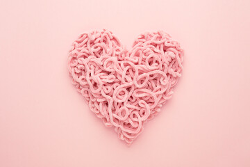 Wall Mural - Valentines Day Heart made of yarn on pink background. Copy space, Flat lay. Compound love symbol.