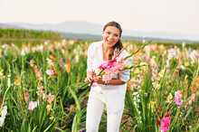 Happy Laughing Woman Cutting Gladiolus On Flower Farm, Hobby And Leisure, Nature Lifestyle