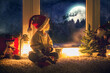 Cute child, sitting on a window, looking outdoors for Santa Claus
