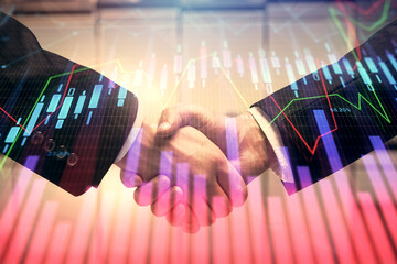 Double exposure of forex graph hologram and handshake of two men. Stock market concept.