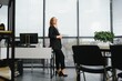 © Serhii - Portrait of smiling modern business woman in office