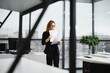 © Serhii - Portrait of smiling modern business woman in office