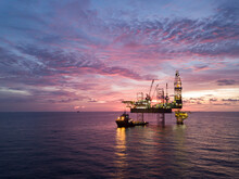 Aerial View Offshore Drilling Rig (jack Up Rig) At The Offshore Location During Sunset