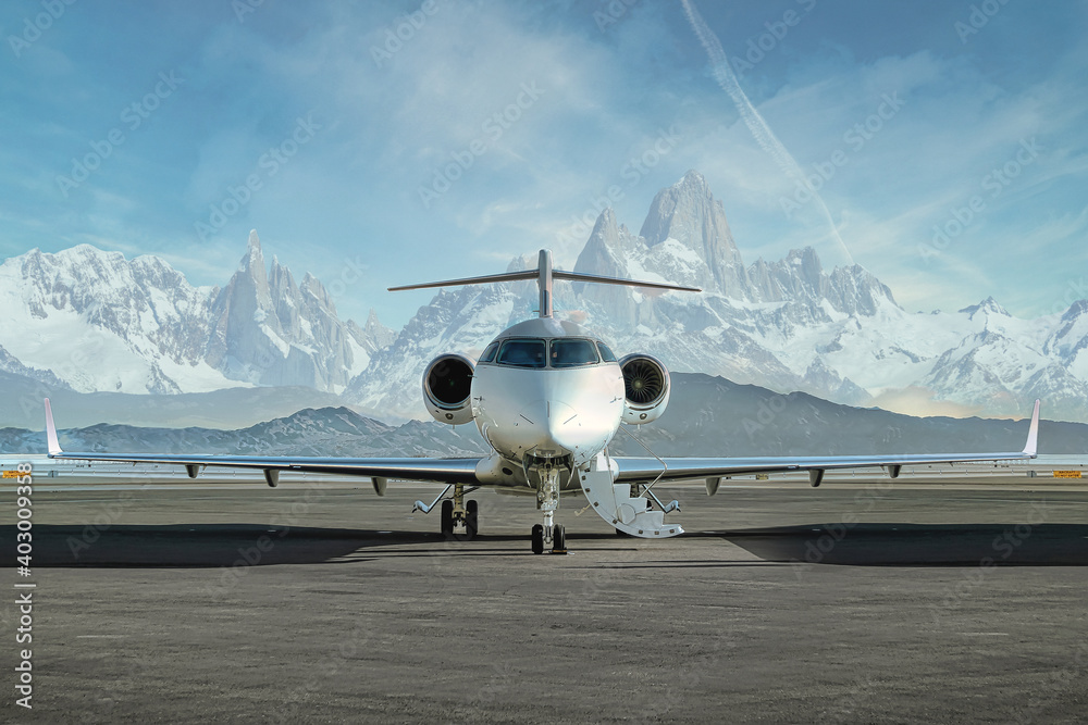 private jet airplane on the ground waiting to be boarded
snowy mountains in the background - obrazy, fototapety, plakaty 