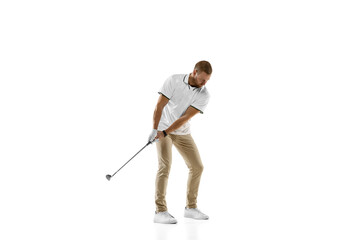 Wall Mural - Balance. Golf player in a white shirt practicing, playing isolated on white studio background with copyspace. Professional player practicing with bright emotions and facial expression. Sport concept.