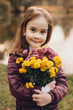 © Strelciuc - Lovely caucasian girl looking at camera and posing with some flowers with a lake on background in the park