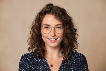 Fototapete - Portrait of happy young woman wearing spectacles