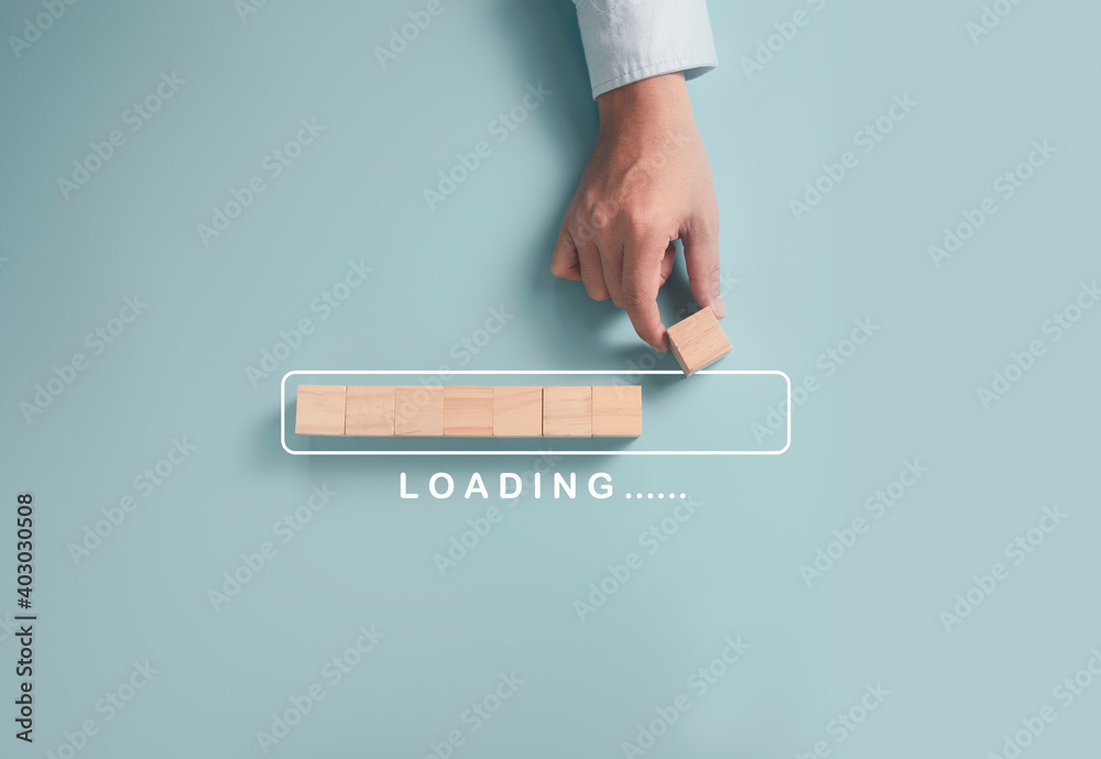 Download Upload data information and business progressive concept, Businessman putting wooden cube block on light blue background. - obrazy, fototapety, plakaty 