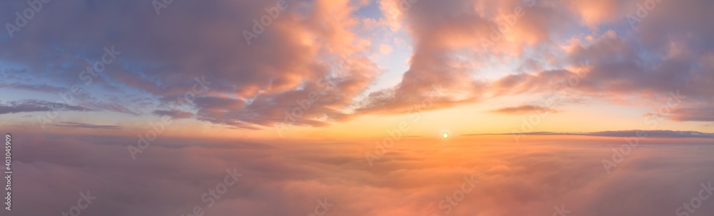 Sunrise panorama in lilac and pale pink shades with cirrus clouds. Sky background. View from the plane during the flight on vacation - obrazy, fototapety, plakaty 