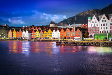 Fototapete - Bryggen in Bergen at night. Traditional colorful wooden houses on the quayside of the historic harbor district. Famous landmark in Norway.