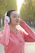 Young women are listening to music outdoors 